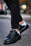Black leather shoes with white soles worn by a person on a blurred street background