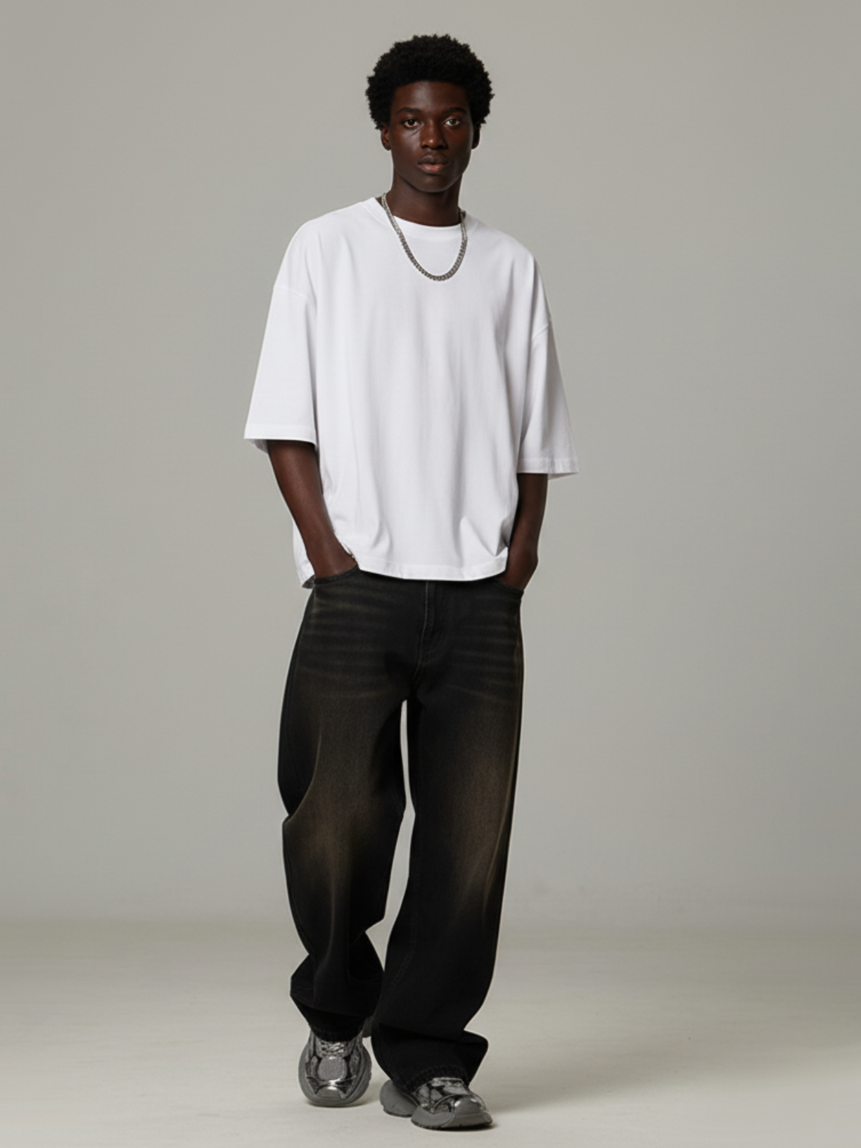 Aero boxy crop tee in white by Apollo Moda, oversized fit worn with black pants